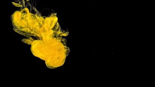 Abstract Yellow Ink Swirling on Black Background