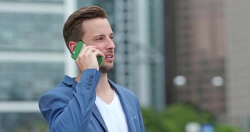 Man Talking on a Cell Phone in City