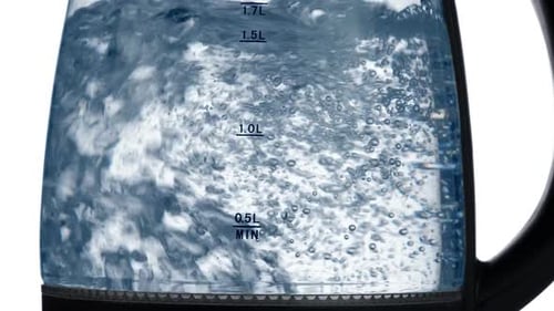 Water Boiling in Glass Kettle Close Up