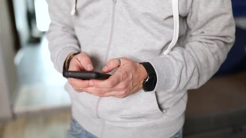 Man Hold Smartphone in Two Hands Typing Text Enjoying Communication with Friends