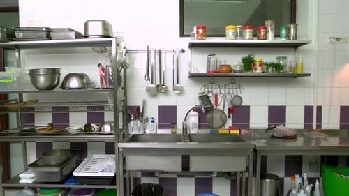 Commercial Kitchen with Stainless Steel Shelves and Utensils