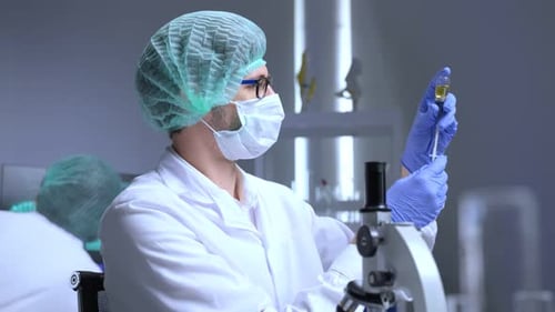 Scientist Holding Syringe with Vaccine in a Laboratory