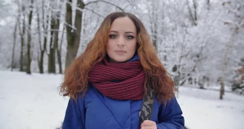 Young Girl Walks In A Snowy Park