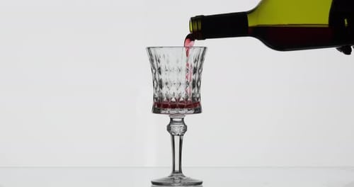 Pouring Red Wine into a Clear Glass