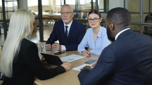 Company Director Discussing Agreement Details Business Partners Sitting Table