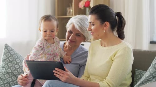 Mother, Daughter and Grandmother on Sofa at Home