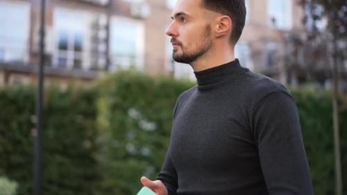Side View Young Caucasian Successful Businessman Closing Tablet Looking Around and Looking at Camera