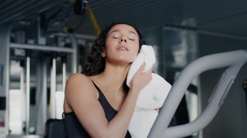 Woman Wipes Sweat After Gym Workout