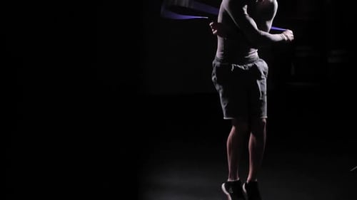 Man Working Out Jumping Rope at Night