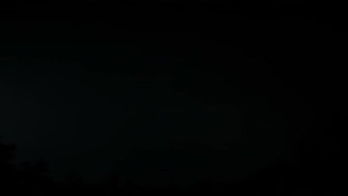 Lightning Strikes Against Stark Black Background at Night