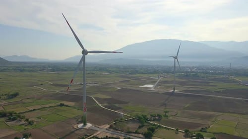 Aerial Shot of a Complex of Wind Turbines Standing on a Big Farming Field. Green Energy Concept