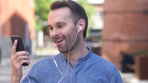 Man Talking on a Video Call Outside
