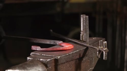 Blacksmith Shapes Red-Hot Horseshoe on Anvil