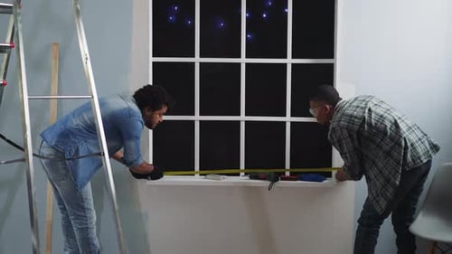 Black Employees Measure Window Width with Retractable Tape