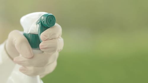 Hand Sprays Disinfectant from Bottle in Close Up