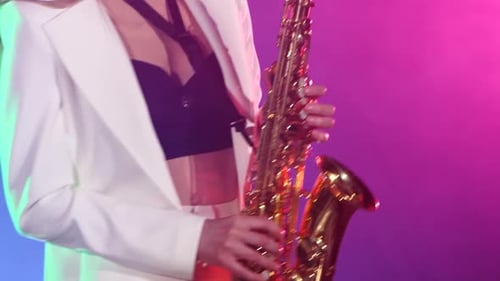Saxophone Player Performing in Club at Night