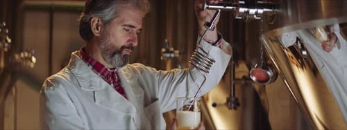Un expert brassicole prélève un échantillon de bière