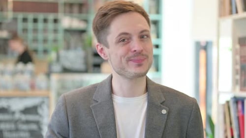 Man Smiling Giving Thumbs Up to Camera