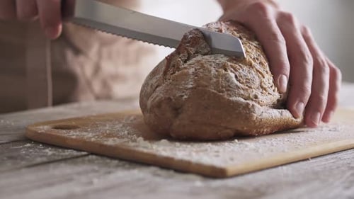 Slicing a Crusty Loaf of Bread