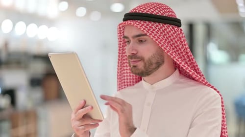 Man Using Tablet in Office Setting