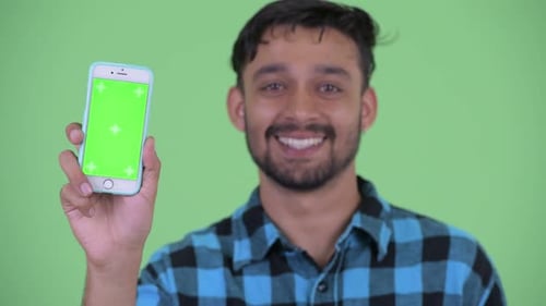 Smiling Man Holding Phone with Chroma Key Screen
