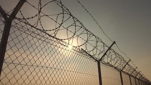 Barbed Wire Fence At Sunset
