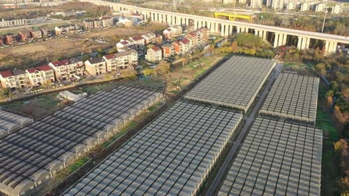 Aerial View of Greenhouses Near an Urban Neighborhood