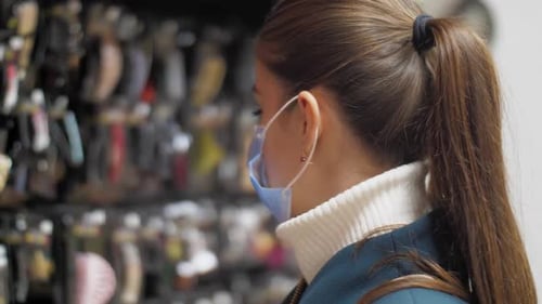 Woman Shops for Hair Accessories Wearing Face Mask