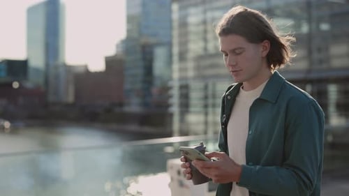 Young Adult Using Phone in Urban Setting