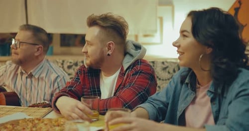 Friends Enjoying Pizza and Drinks Together