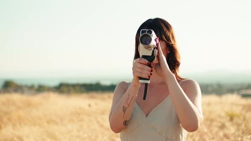 Young Woman Filming with Vintage Super 8 Camera