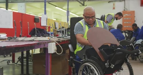 Workers Assembling Wheelchairs in a Factory