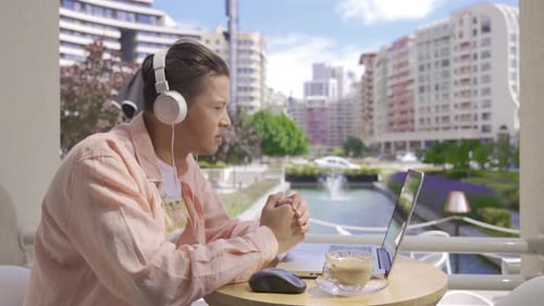 Young man video chatting in cafe.