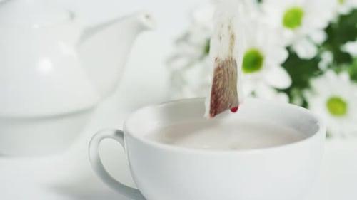 Steeping a tea bag into the water