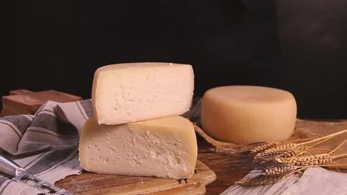 Women hands take away pieces of fresh homemade cheese close up