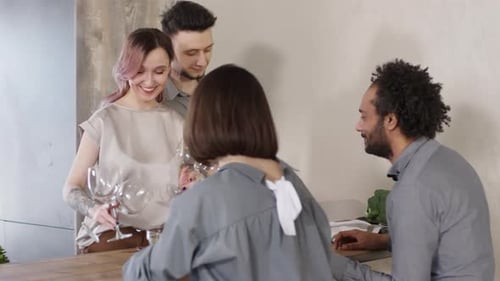 Friends Preparing Food and Wine in Kitchen