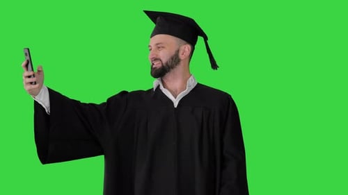 Excited Graduate Student Taking a Selfie on a Green Screen, Chroma Key.