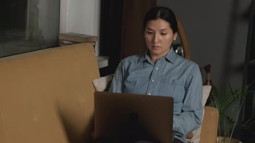 Woman Uses Laptop at Home on Couch