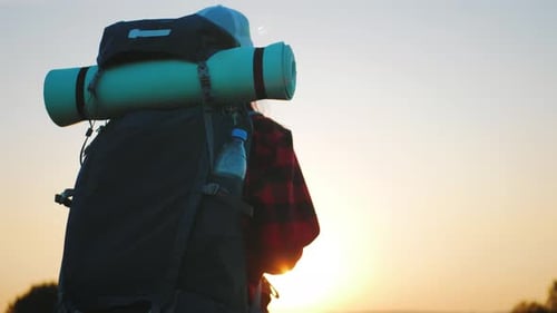 Backpacker Silhouetted Against Beautiful Sunrise Landscape