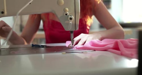 Female Hands Using a Sewing Machine at a Textile Workshop