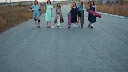 Women with Longboards in Hand Are Standing on a Road, Sporty Ladies,