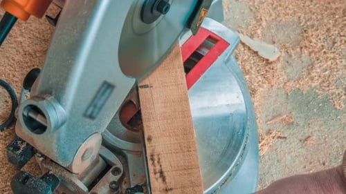 Carpenter Using Circular Saw for Cutting Wooden Boards