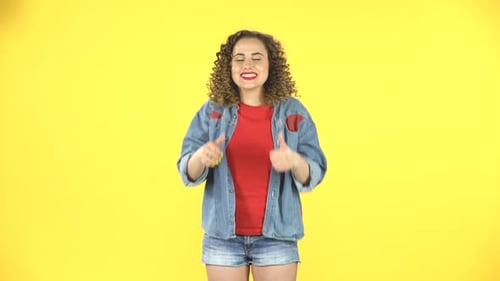 Woman Gives Thumbs Up on Yellow Background