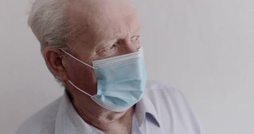 Senior Man Wearing Surgical Mask Close Up