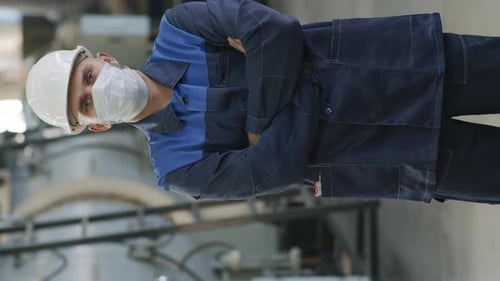 Vertical Portrait of Factory Worker in Uniform and Face Mask