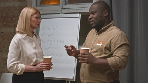 Two Professionals Discuss Process in an Office