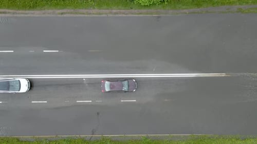Aerial View of City Traffic with Cars Driving on Flooded Street After Heavy Rain