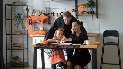 Family Drawing Together at Halloween Celebration
