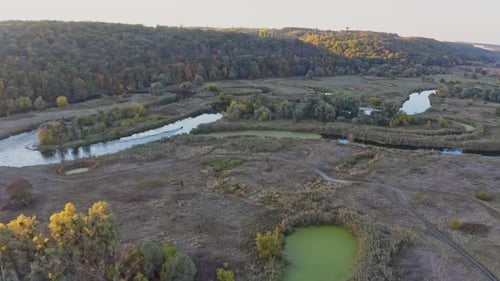 Small Motorboat Sails on Long Curvy River Running on Meadows