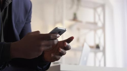 Adult Typing on Cell Phone at Home